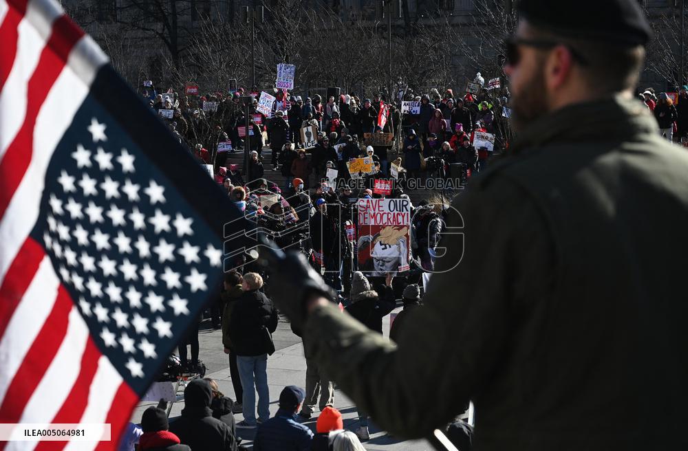 People protest on the first anniversary of President Donald Trump's second term in office