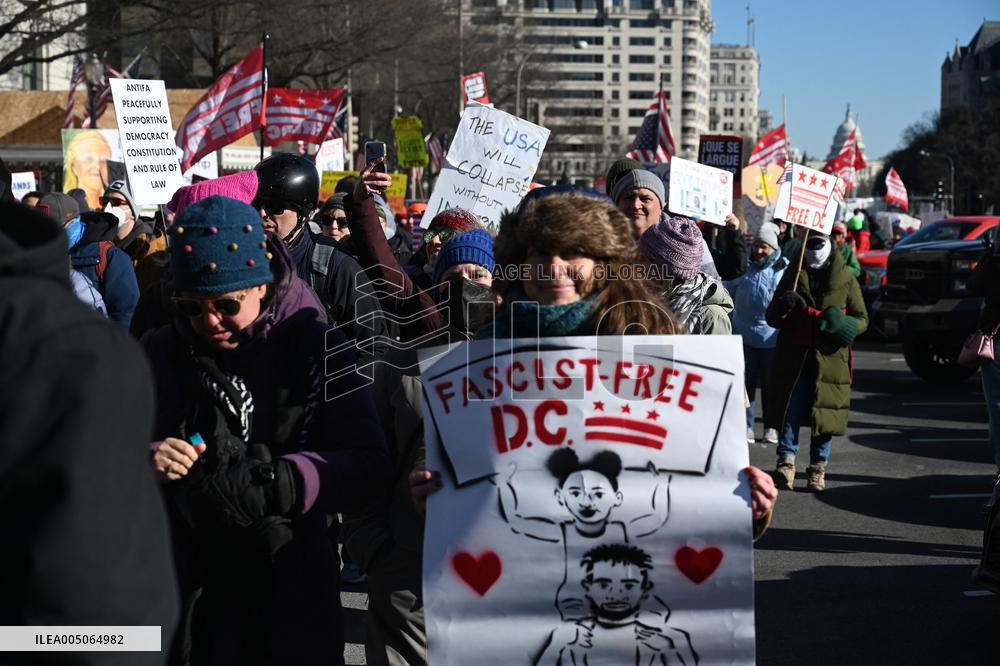 People protest on the first anniversary of President Donald Trump's second term in office