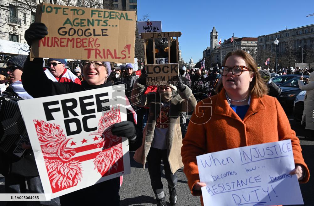 People protest on the first anniversary of President Donald Trump's second term in office