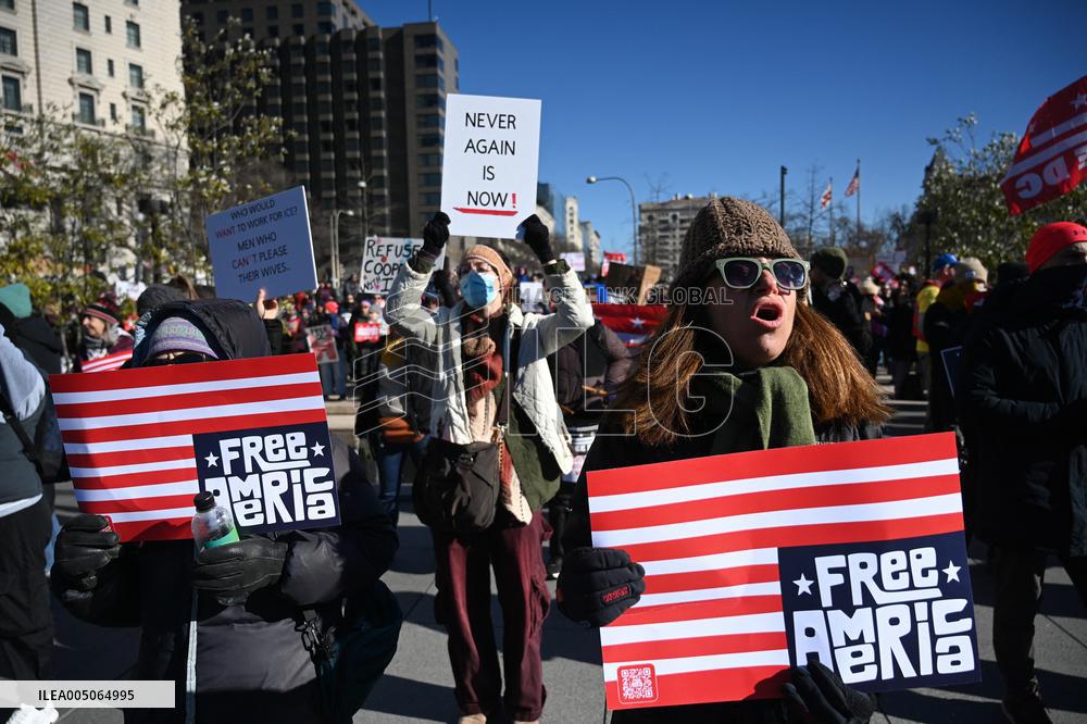 People protest on the first anniversary of President Donald Trump's second term in office