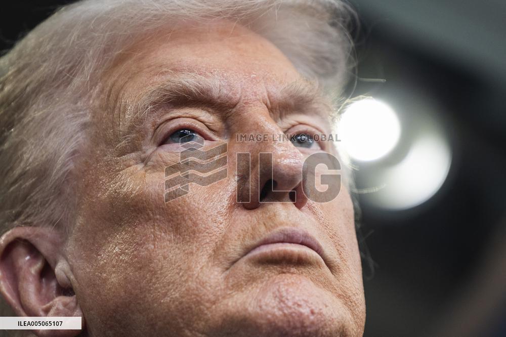 US President Trump speaks on to reporters ahead of trip to Davos