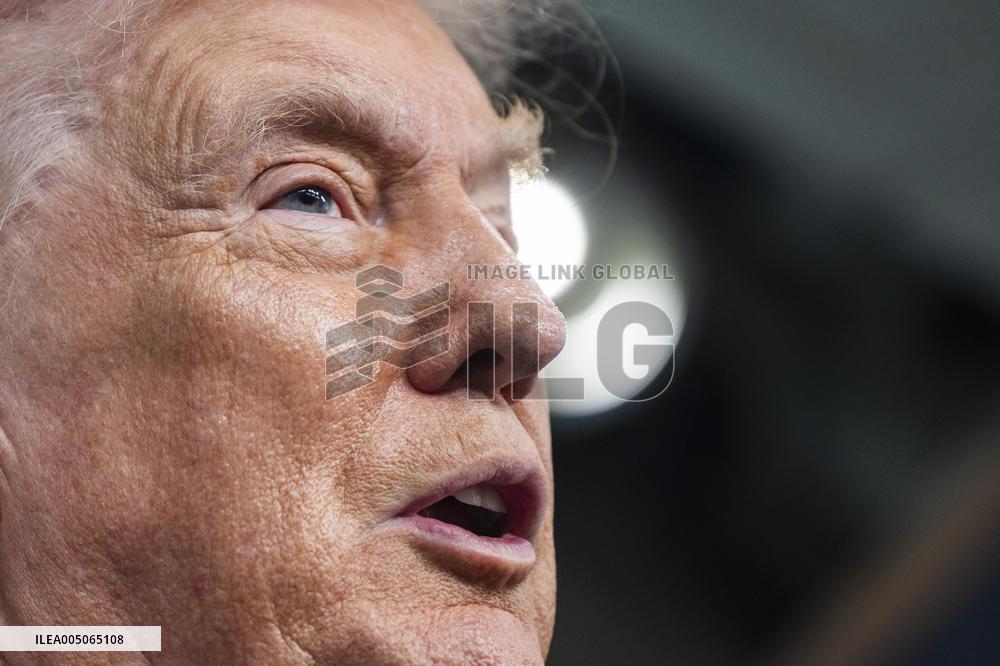 US President Trump speaks on to reporters ahead of trip to Davos