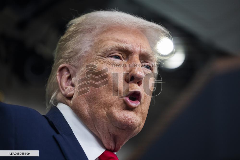 US President Trump speaks on to reporters ahead of trip to Davos