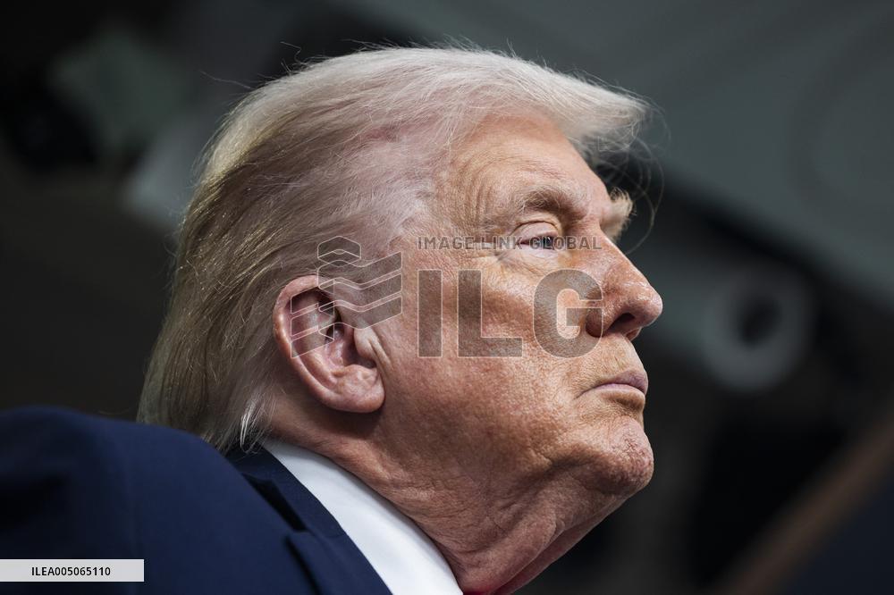 US President Trump speaks on to reporters ahead of trip to Davos