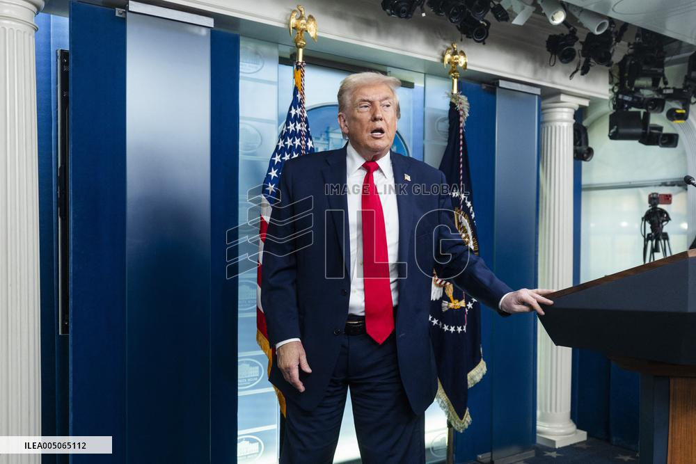 US President Trump speaks on to reporters ahead of trip to Davos