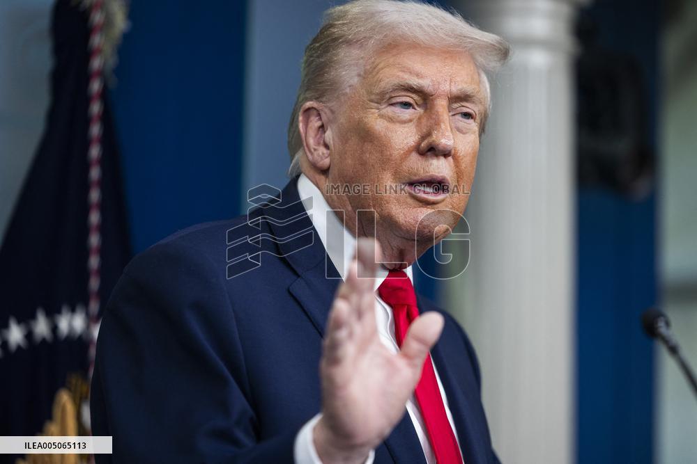 US President Trump speaks on to reporters ahead of trip to Davos