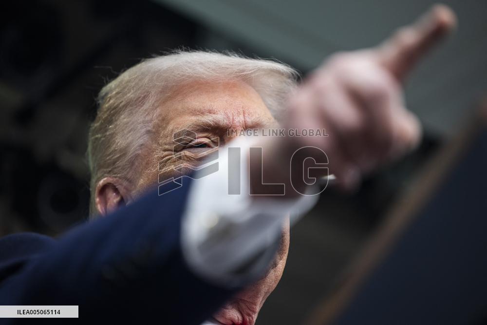 US President Trump speaks on to reporters ahead of trip to Davos