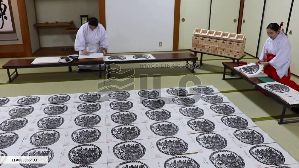 Making of paper charms at Japanese shrine