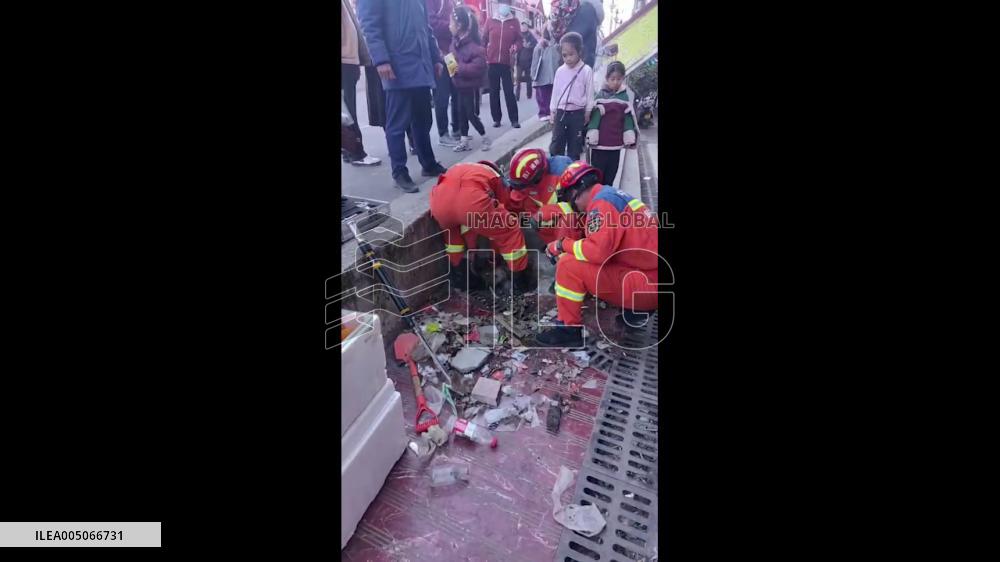 China: Firefighters Break Through Newly Paved Road to Rescue Trapped Dog