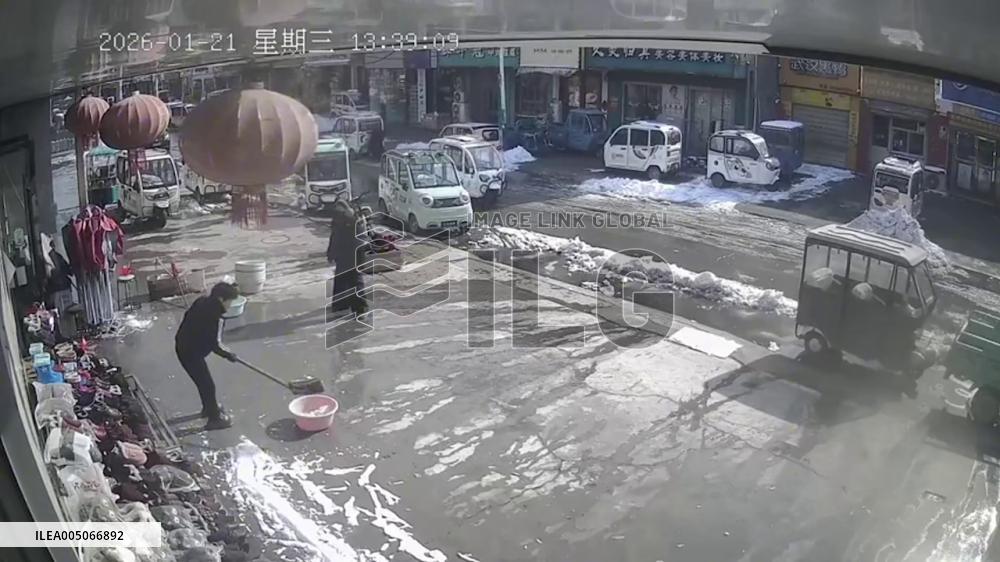 China: Roof Snow Collapses Moments After Person Steps Away