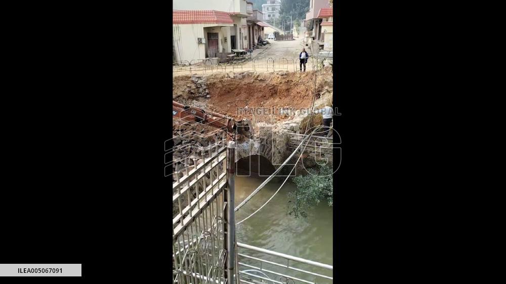 China: Excavator Plunges Into River as Stone Bridge Collapses During Demolition