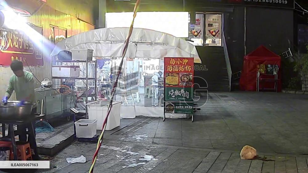 China: Man Narrowly Escapes Falling Flowerpot While Feeding Stray Cat