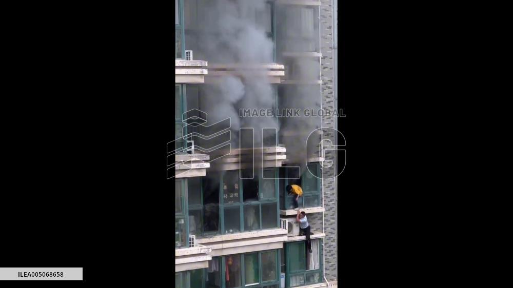 China: Man Rescues Child Trapped on Window Ledge From Apartment Fire