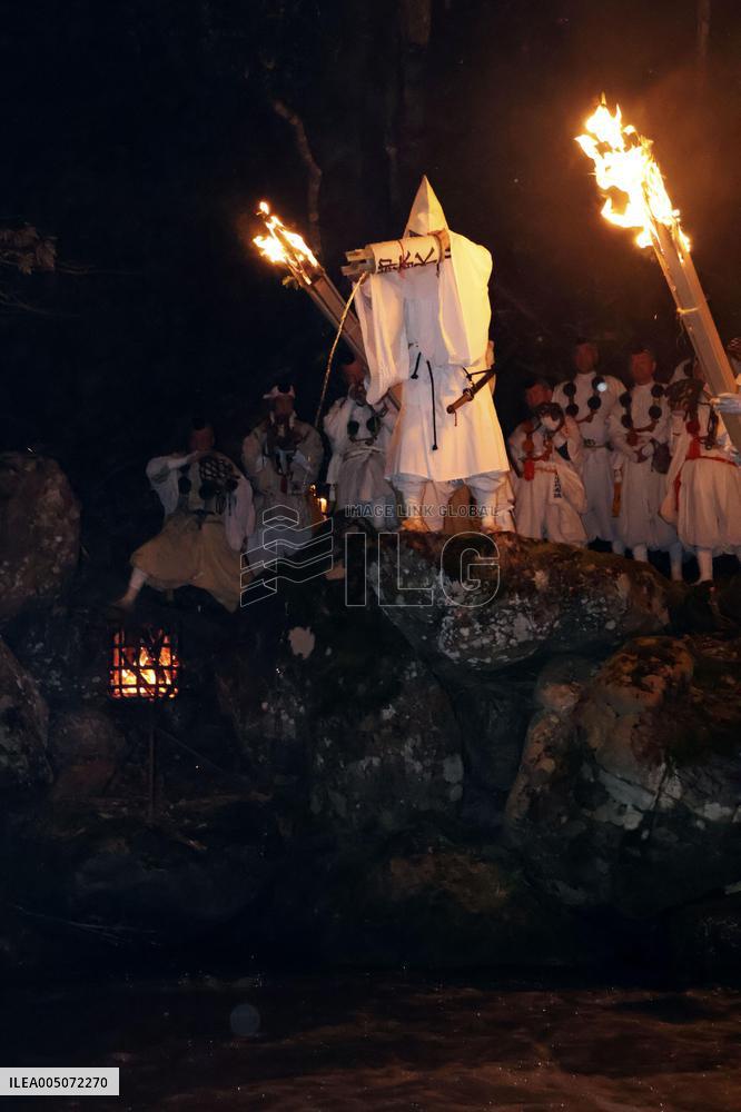 Ritual to pour holy water into river in Japan