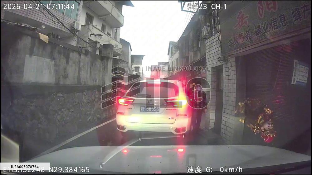 China: Delivery Rider Leaps to Safety as Car Speeds Out in Narrow Alley