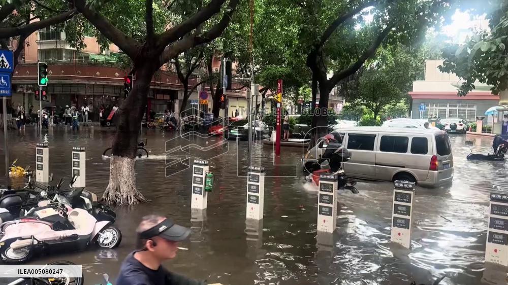 China: Delivery Rider Surfs Through Flooded Streets Bouncing on Scooter in Zhengzhou