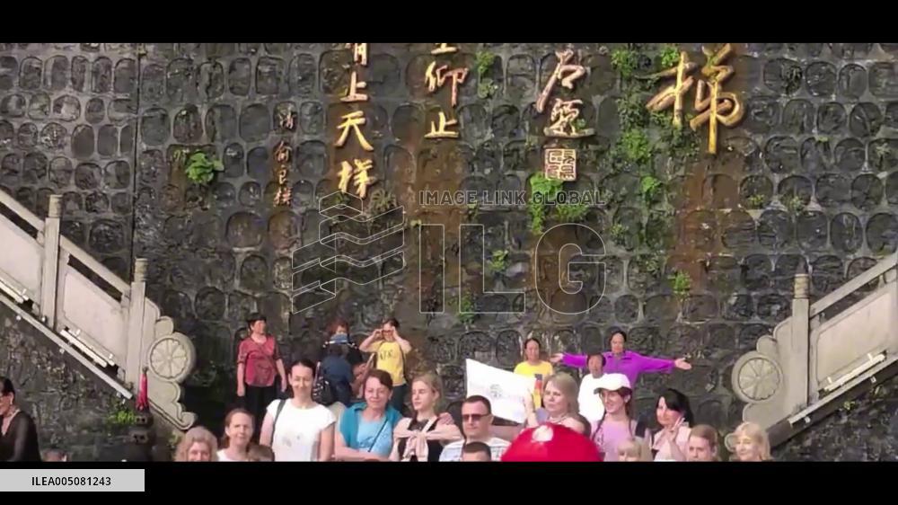 China: Tourists Watch Rocks Crumble From Cliff Behind Tianmen Cave in Zhangjiajie