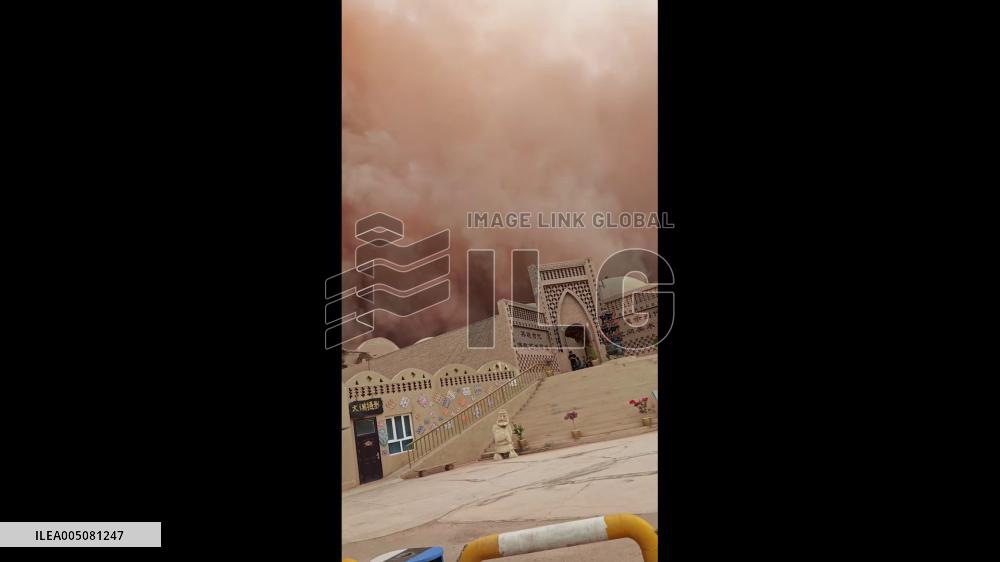 China: Reddish-Orange Sandstorm Engulfs Tourist Site Near Flaming Mountain in Xinjiang