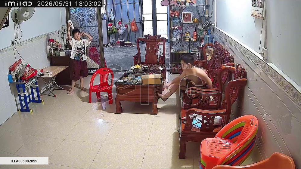 China: Young Boy Calmly Unplugs Flaming Hair Dryer in Guangdong