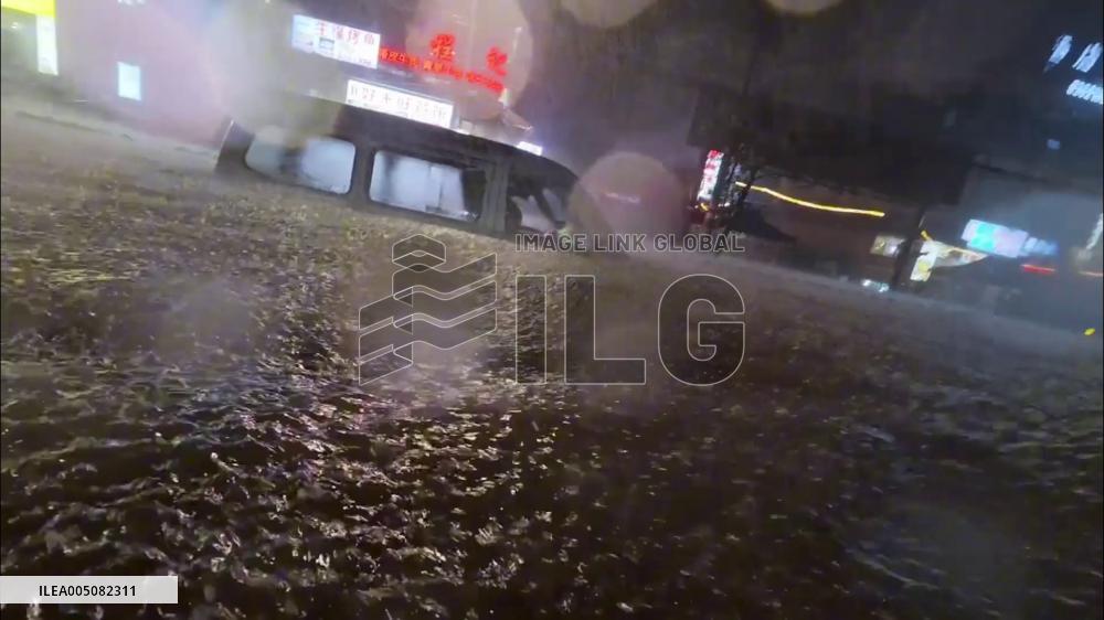 China: Police Rescue Driver Trapped in Car amid Heavy Street Flooding