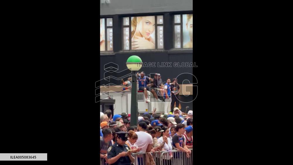 US: Knicks Fans Climb Street Infrastructure Ahead of Championship Parade