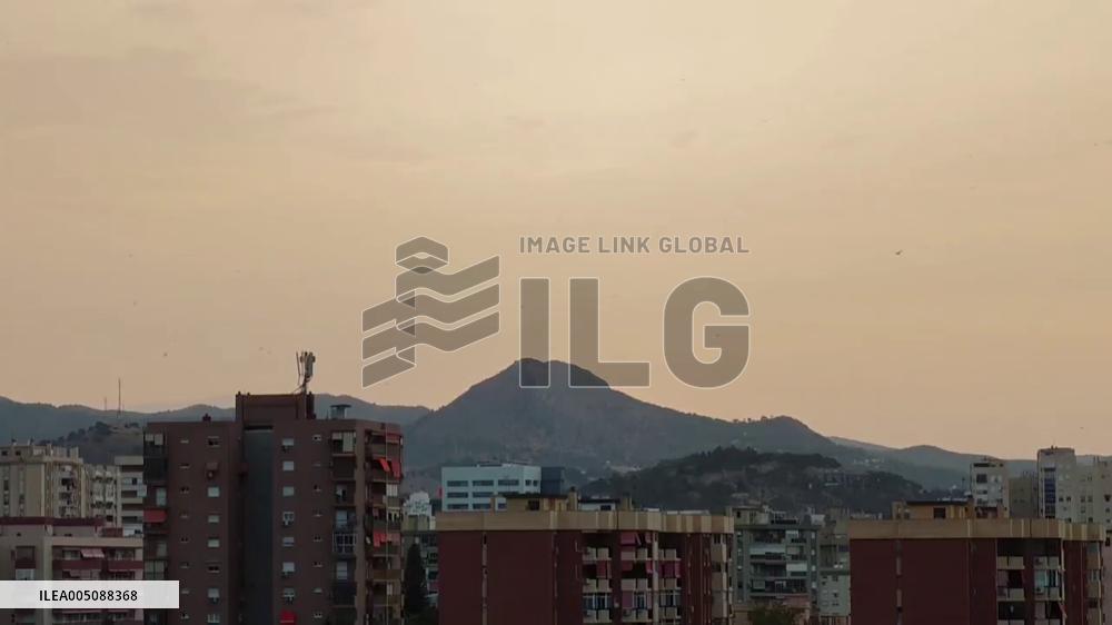 Spain: Saharan Dust Haze Blankets Malaga at Sunrise
