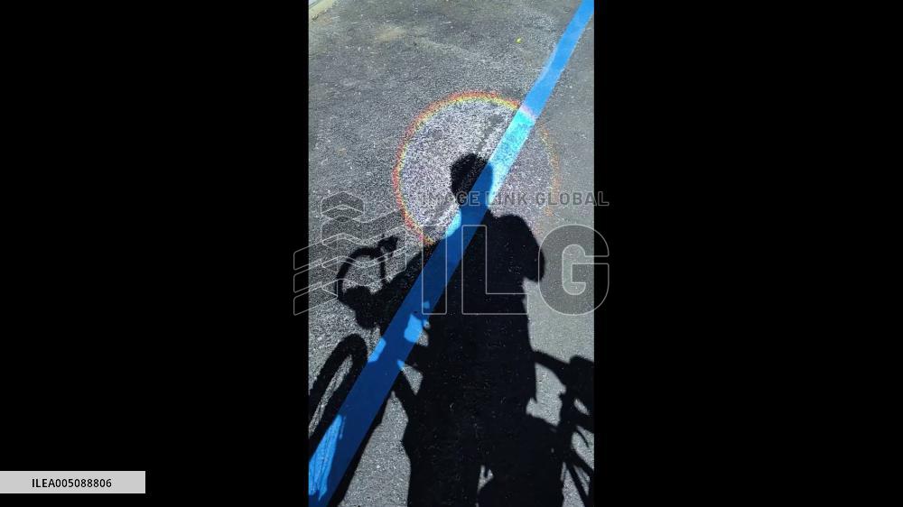 Switzerland: Colorful Rainbow Circle Forms Around Man’s Head Shadow