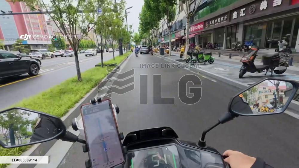 China: Careless Car Door Opening Sends Scooter Rider Crashing in Jiangsu