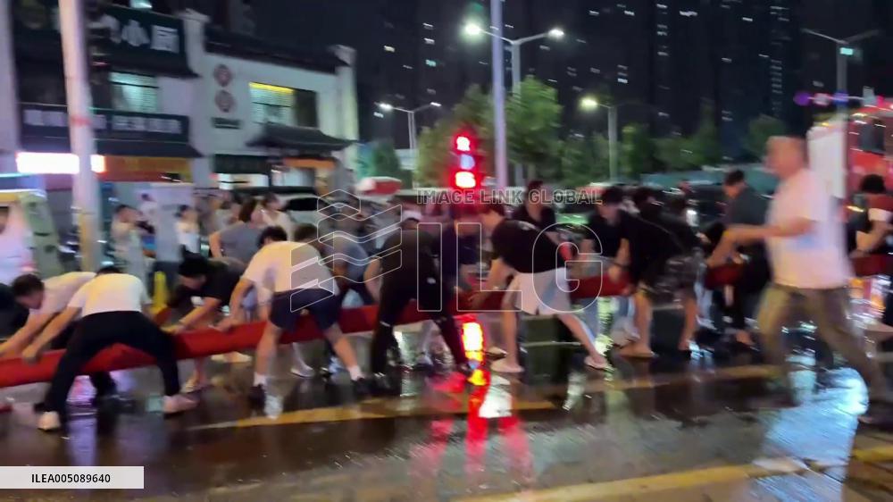China: Residents Form Human Chain to Aid Firefighters at Zhengzhou Auto Market Blaze
