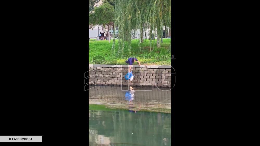 China: Men Rescue Drowning Dog From Steep Riverbank
