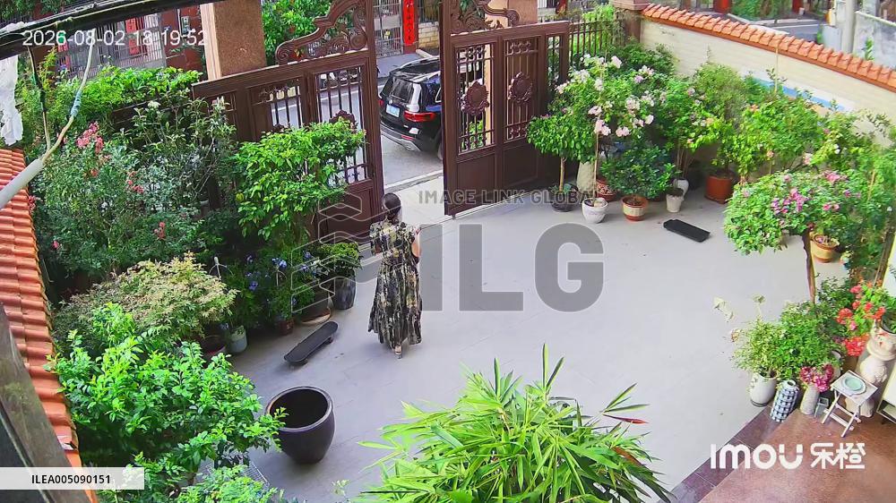 China: Woman Narrowly Escapes as Plant Blocks Falling Gate