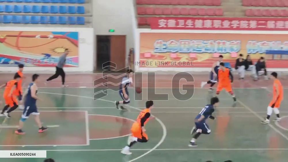 China: Basketball Player Crashes Through Glass Door