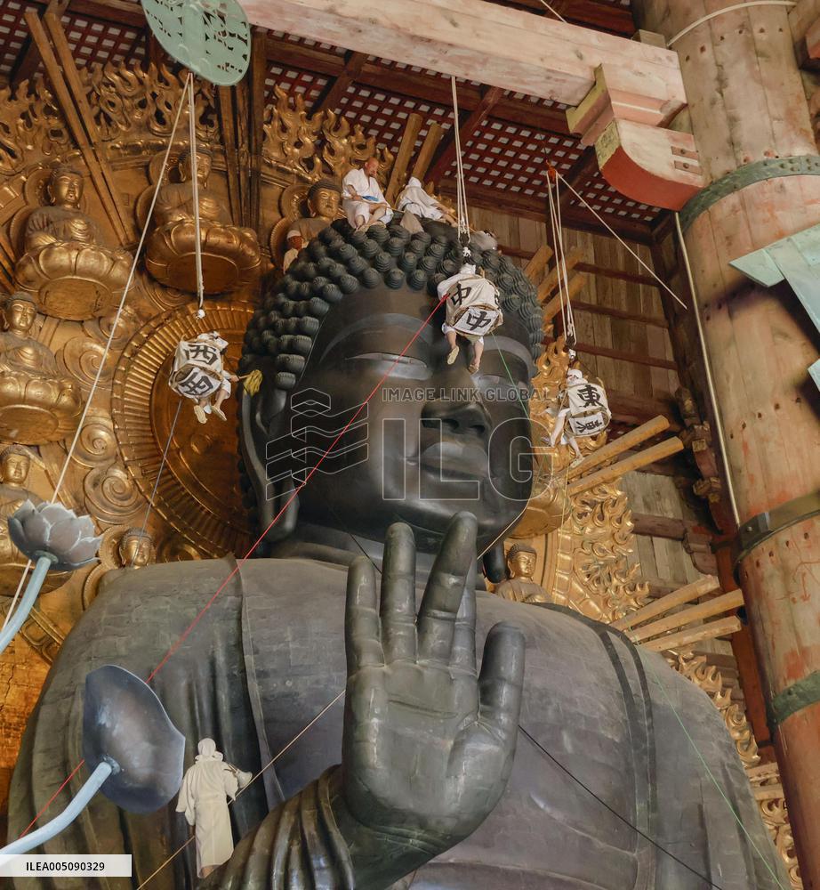 Annual cleaning of Great Buddha of Nara