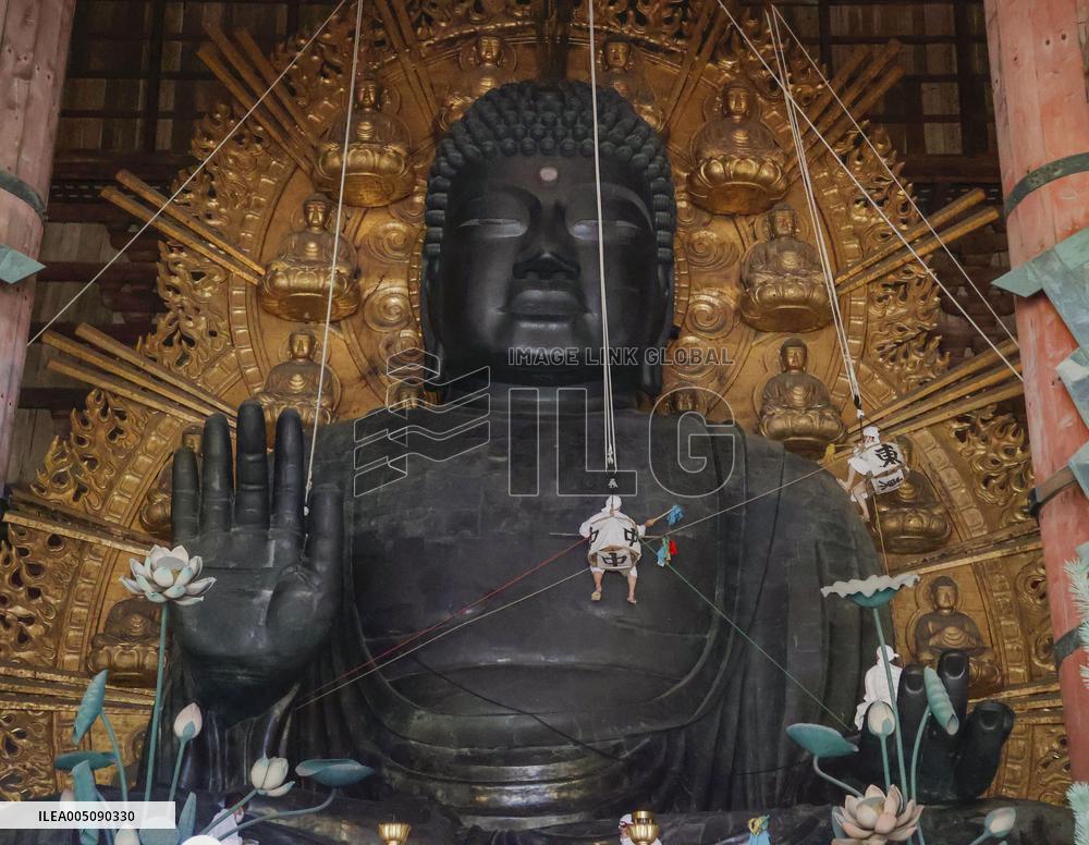 Annual cleaning of Great Buddha of Nara