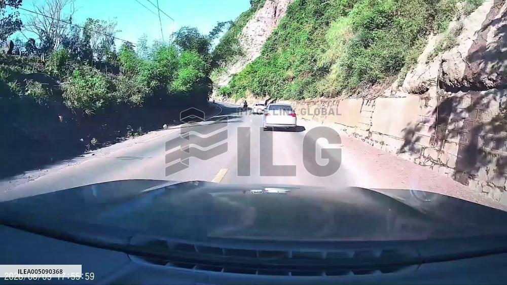 China: Landslide Debris and Boulders Crush Vehicle on Mountain Road